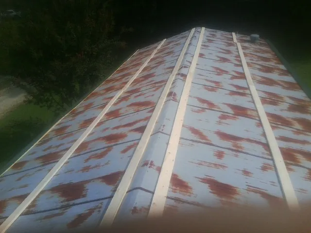 Rusted metal roof panels with new wood purlins before replacement — Storm Damage Roof Repair in Shalimar by Roofing Brothers
