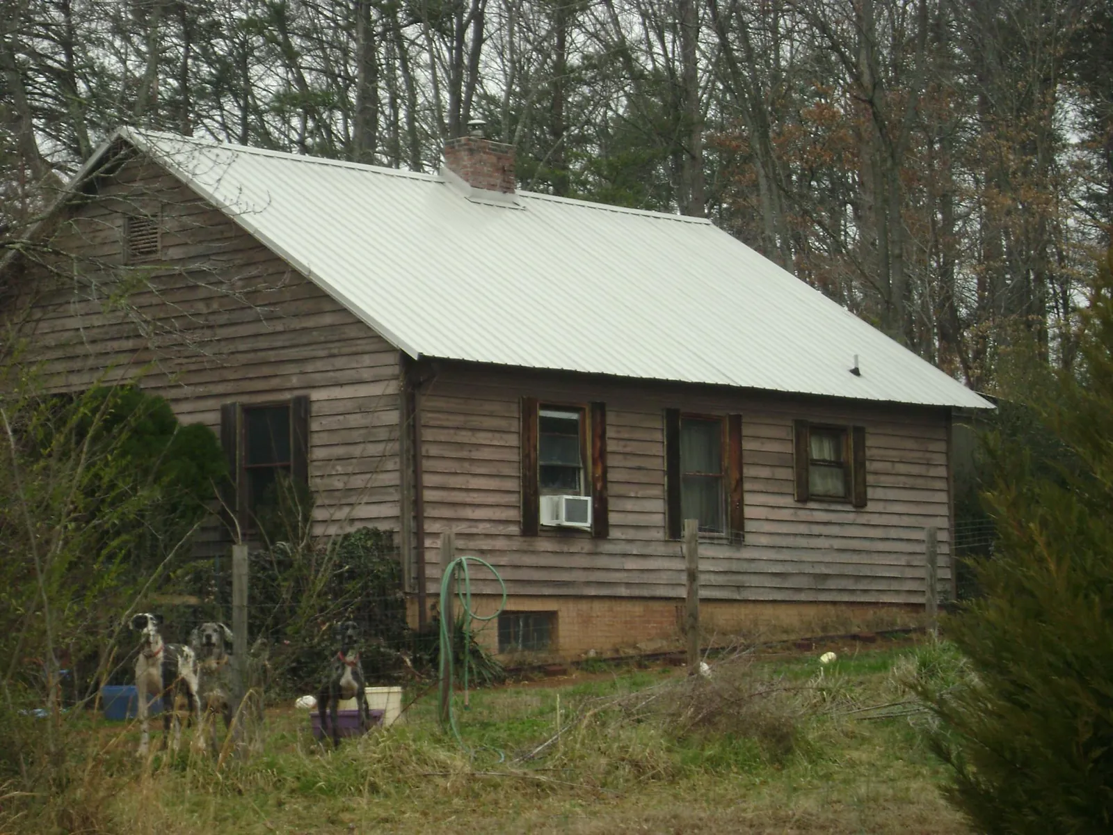 White metal roof on an old wood sided farmhouse, from a Asphalt Shingle Roof Repair job in Shalimar
